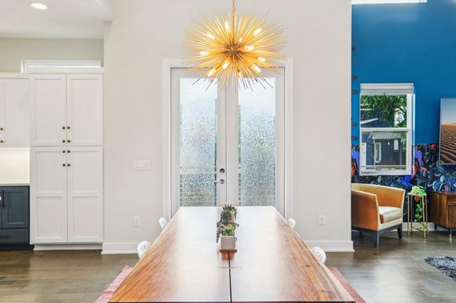 Dining area featuring dark wood finished floors, recessed lighting, a chandelier, and french doors | Image 12