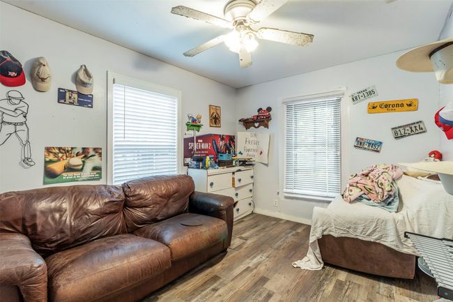 Living area with baseboards, ceiling fan, and wood finished floors | Image 9