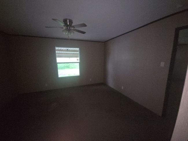 Carpeted empty room featuring ceiling fan | Image 19