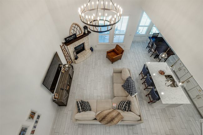 Living area featuring baseboards and a notable chandelier | Image 11