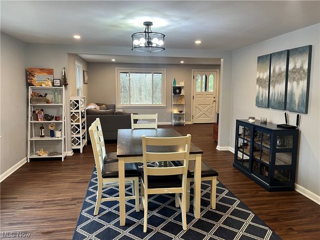 Dining space featuring dark hardwood / wood-style flooring and a chandelier | Image 14