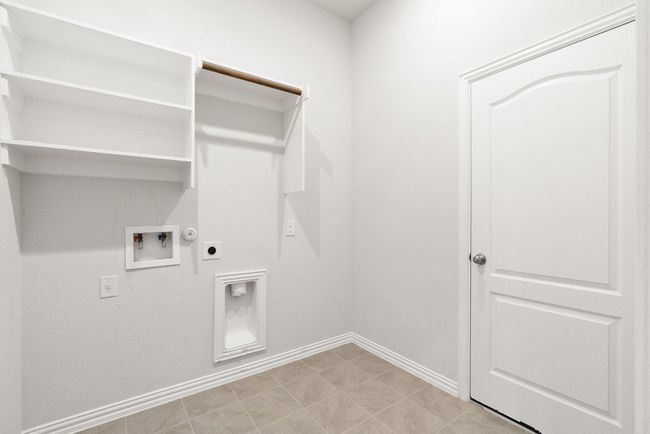 Laundry room with electric dryer hookup, hookup for a washing machine, hookup for a gas dryer, and light tile patterned floors | Image 14