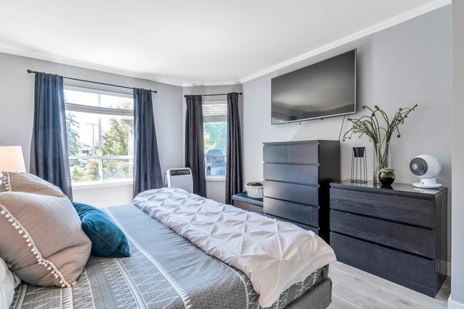 Bedroom featuring light wood finished floors and crown molding | Image 19