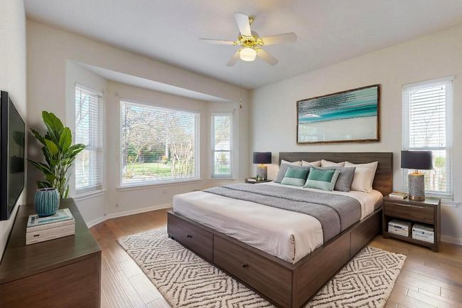 primary bedroom with sitting area overlooking the back yard | Image 19