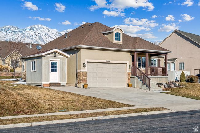 View of front of house featuring a front yard, a garage, covered porch, and a mountain view | Image 38