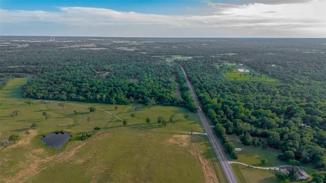 Neighborhood situated in a serene suburb, where charming houses are nestled among lush trees and vibrant greener. | Image 42