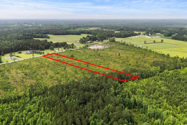 View of rural area featuring a heavily wooded area and property parcel outlined | Image 18