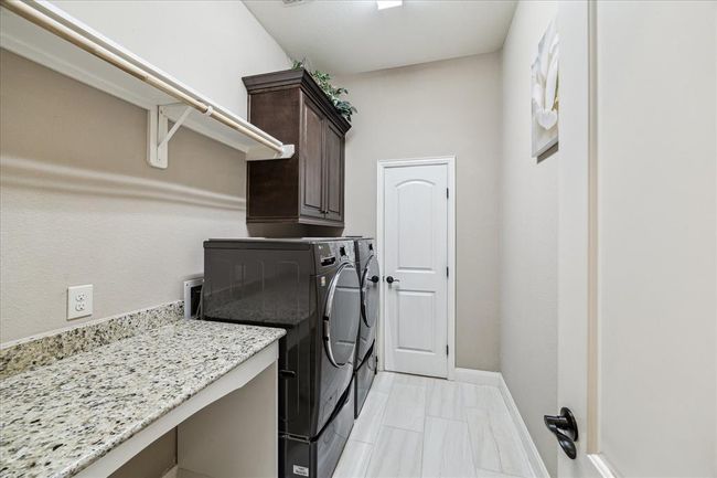 Laundry room on first floor with direct access to primary closet. | Image 26