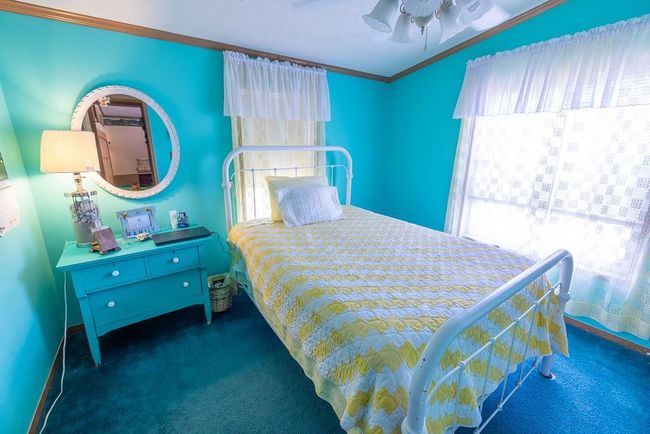 Bedroom featuring carpet, ceiling fan, crown molding, and baseboards | Image 22