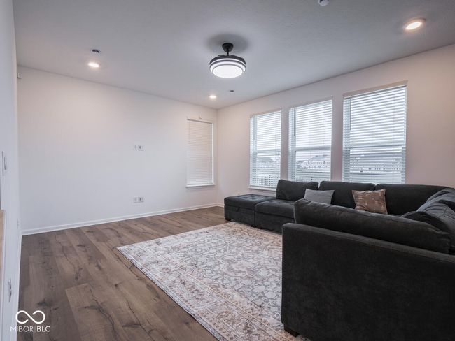 living room featuring baseboards, recessed lighting, and wood finished floors | Image 11