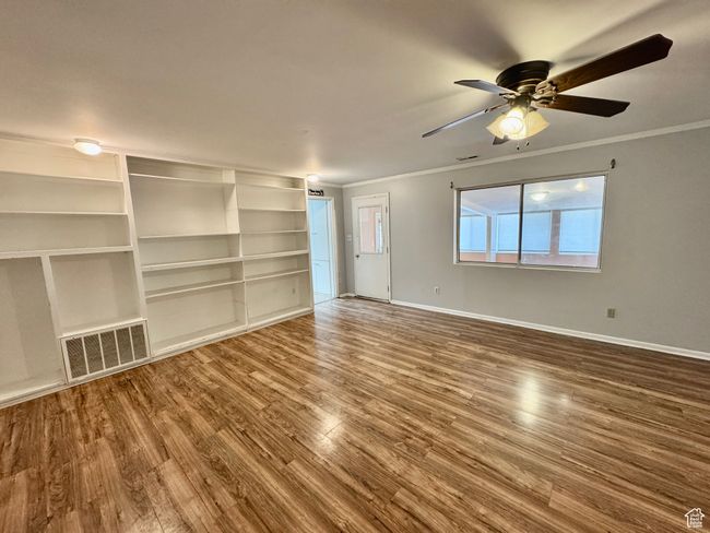 Interior space with visible vents, baseboards, a ceiling fan, and crown molding | Image 27