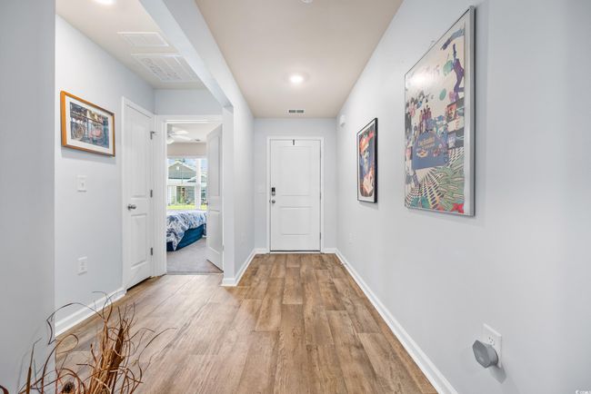 Hallway with light wood-type flooring and baseboards | Image 5