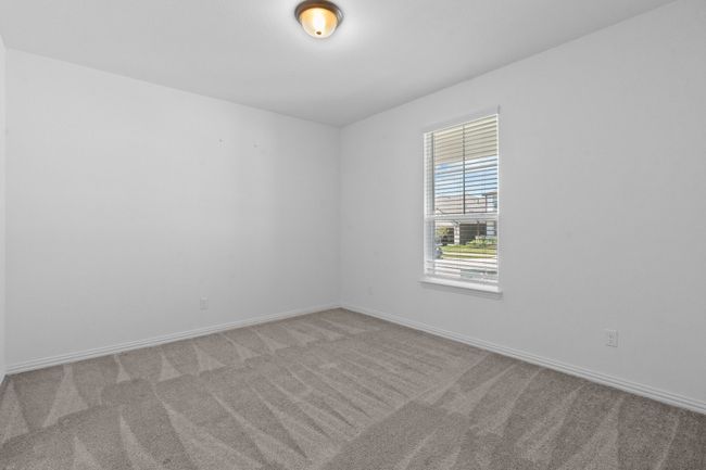 Carpeted empty room featuring baseboards | Image 12