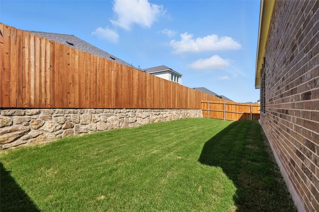 View of fenced backyard | Image 34