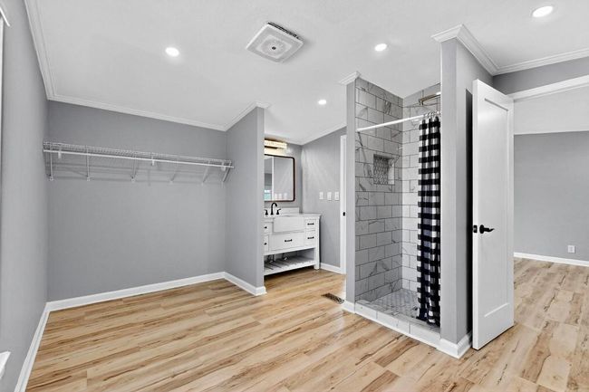Walk in closet featuring light wood finished floors and a sink | Image 26