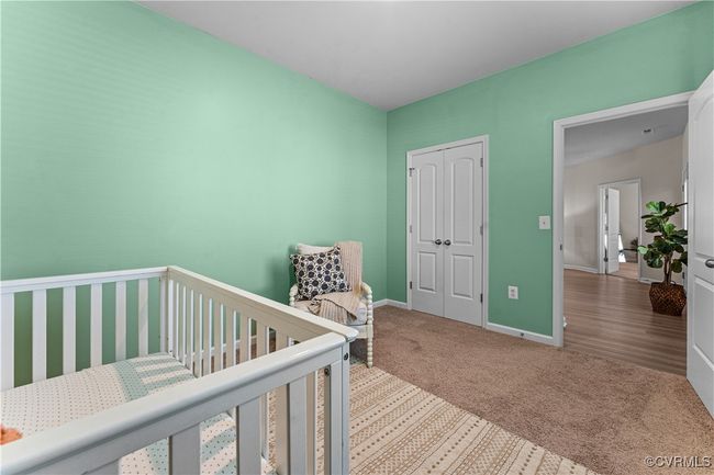 Bedroom with carpet floors, a closet, and baseboards | Image 38