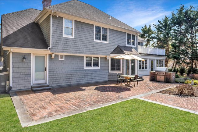 Spacious brick backyard patio with gas grill | Image 25