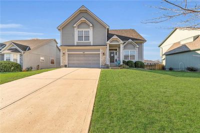 View of front of property featuring a front lawn and a garage | Image 2