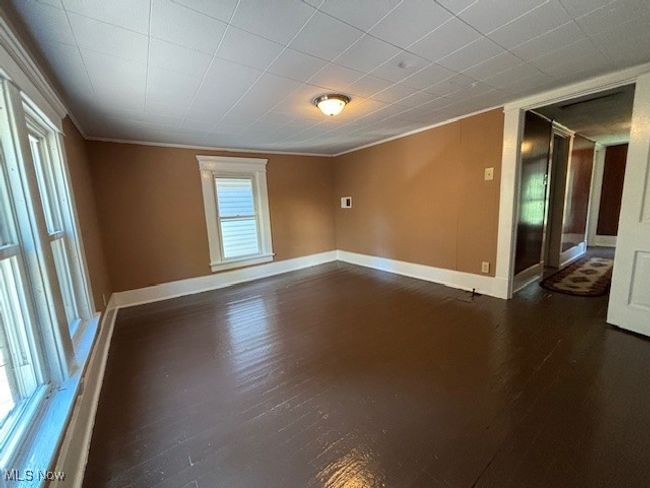 Unfurnished room featuring crown molding and dark hardwood / wood-style flooring | Image 13