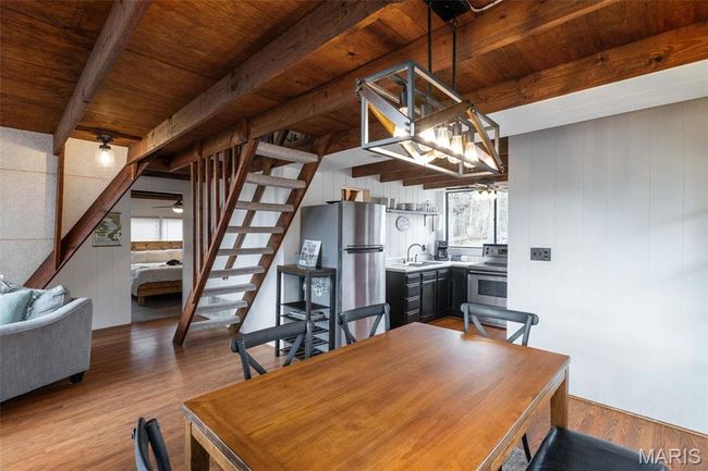 Dining room featuring stairs, beam ceiling, wood finished floors, and wooden ceiling | Image 13