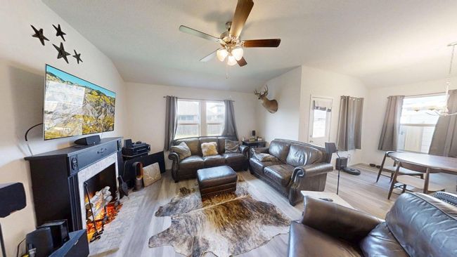 Living area featuring lofted ceiling, ceiling fan, and wood finished floors | Image 22