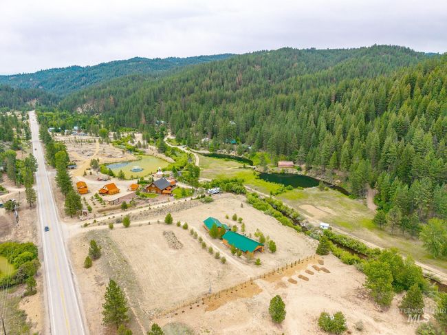 Drone / aerial view of a forest and a mountain backdrop | Image 21