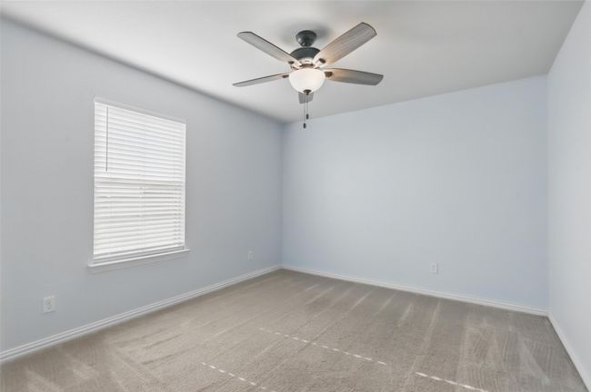Unfurnished room featuring ceiling fan, carpet flooring, and baseboards | Image 18
