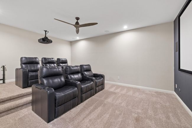Home theater room with carpet flooring, ceiling fan, and recessed lighting | Image 28