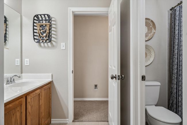 Bathroom featuring toilet, baseboards, and vanity | Image 22