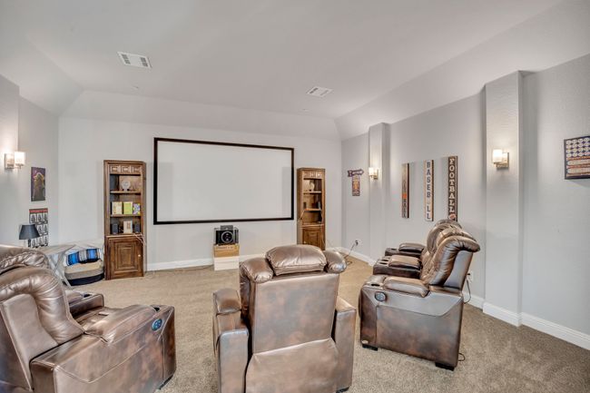Carpeted home theater with lofted ceiling | Image 14