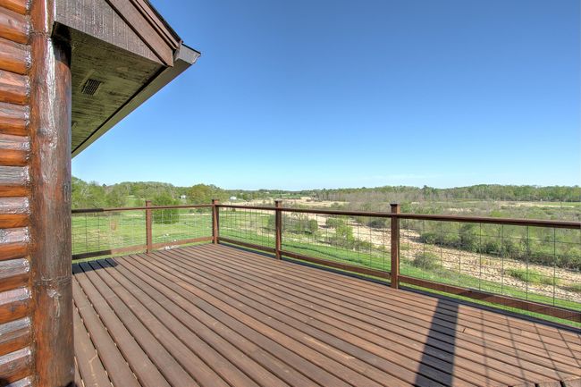 Grill and entertain on the back deck off the kitchen and dining room, while treating yourself and your guests to this beautiful view! | Image 6