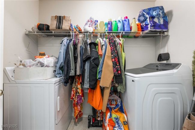 Washroom with washing machine and clothes dryer and laundry area | Image 36