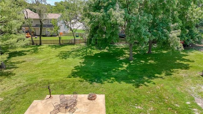 View of yard with a patio area and a fire pit | Image 44