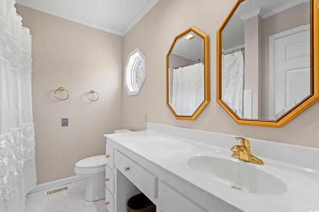 Bathroom featuring ornamental molding, vanity, and tile patterned flooring | Image 12