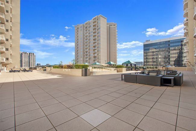 View of patio featuring an outdoor hangout area and a city view | Image 5