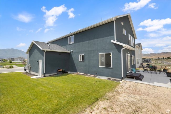 Side of house with a mountain view, stucco siding, a patio area, and a place to park an RV | Image 26