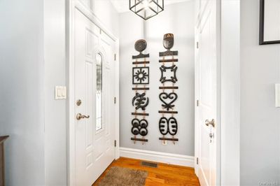 Foyer entrance with ornamental molding and hardwood / wood-style flooring | Image 2