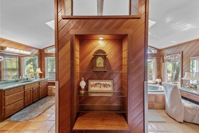 Full bath with tile patterned flooring, vanity, wood walls, and a garden tub | Image 18