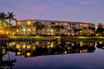 View of Condo 1040, Bldg. 10 (left corner of picture, 3rd floor-end unit) at night with water view. | Image 1