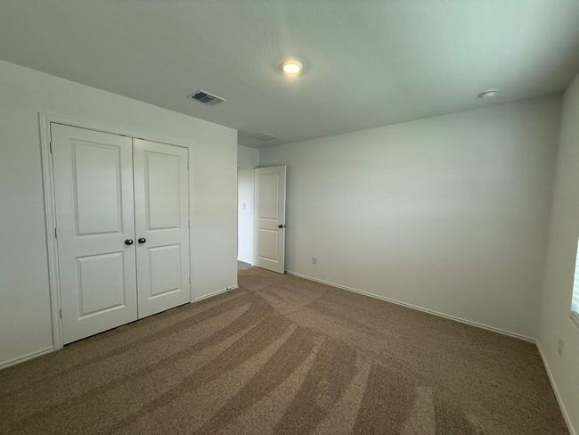 Unfurnished bedroom with carpet flooring, baseboards, and a closet | Image 10