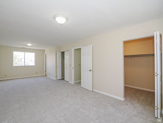 Unfurnished bedroom featuring carpet flooring and a walk in closet | Image 39