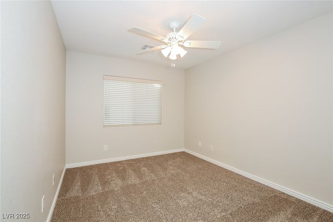Empty room featuring a ceiling fan, carpet floors, and baseboards | Image 10