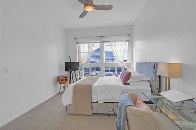 Carpeted bedroom with ceiling fan and baseboards | Image 10