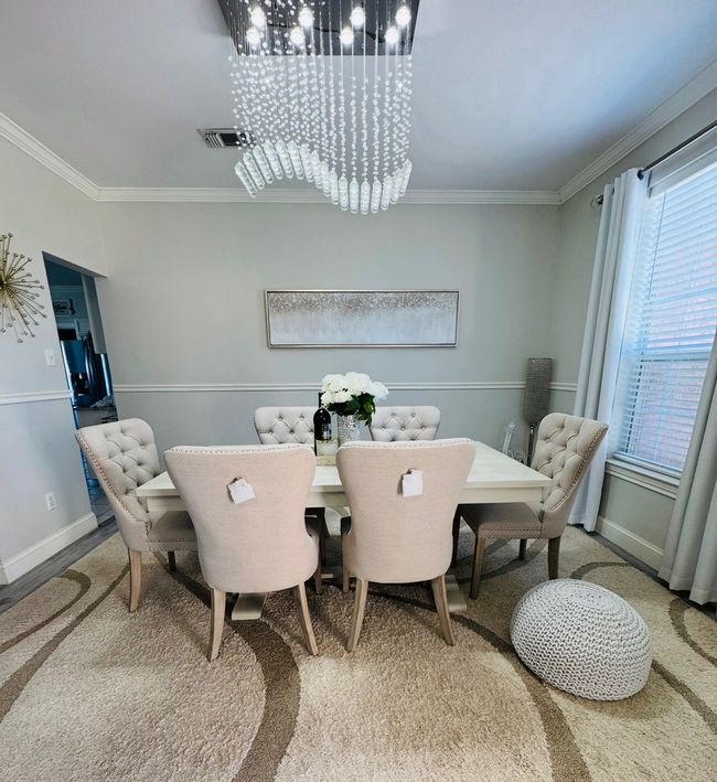 Dining area featuring a chandelier and crown molding | Image 9