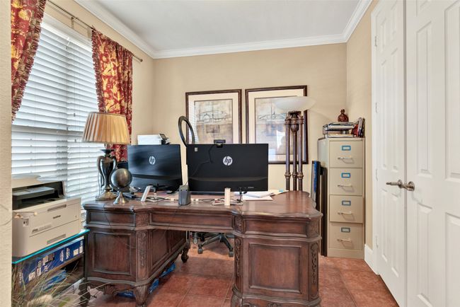 One side of the foyer is this cozy home office with a closet for storage. | Image 6