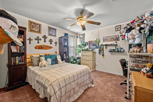 This bedroom is complete with a ceiling fan | Image 17