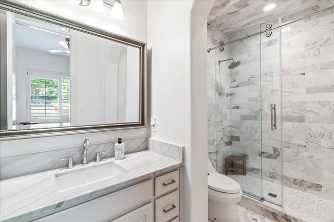 Full bath with a stall shower, vanity, and toilet | Image 28