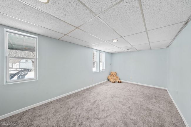Basement featuring a paneled ceiling and carpet | Image 29