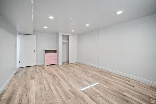 Unfurnished bedroom with recessed lighting, light wood-style flooring, baseboards, and a closet | Image 18