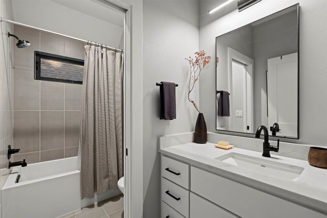 Full bath featuring vanity, shower / bathtub combination with curtain, and tile patterned floors | Image 36